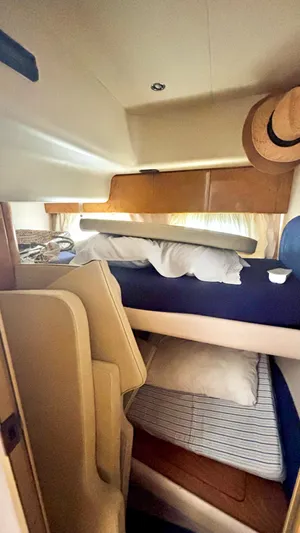  Yacht Photos Pics Interior cabin of 1994 Princess 45 Flybridge yacht with bunk beds and cozy decor.