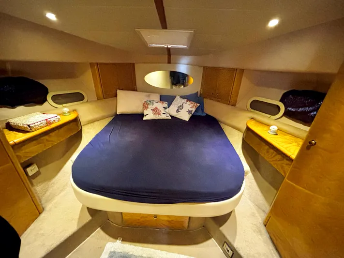  Yacht Photos Pics Luxurious cabin interior of 1994 Princess 45 Flybridge yacht with cozy bed and ambient lighting.