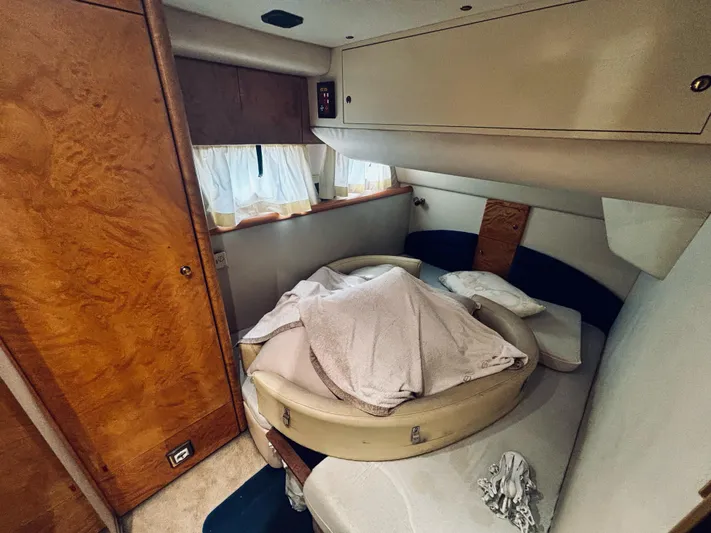  Yacht Photos Pics Cozy cabin interior of 1994 Princess 45 Flybridge yacht with wooden accents and bed.