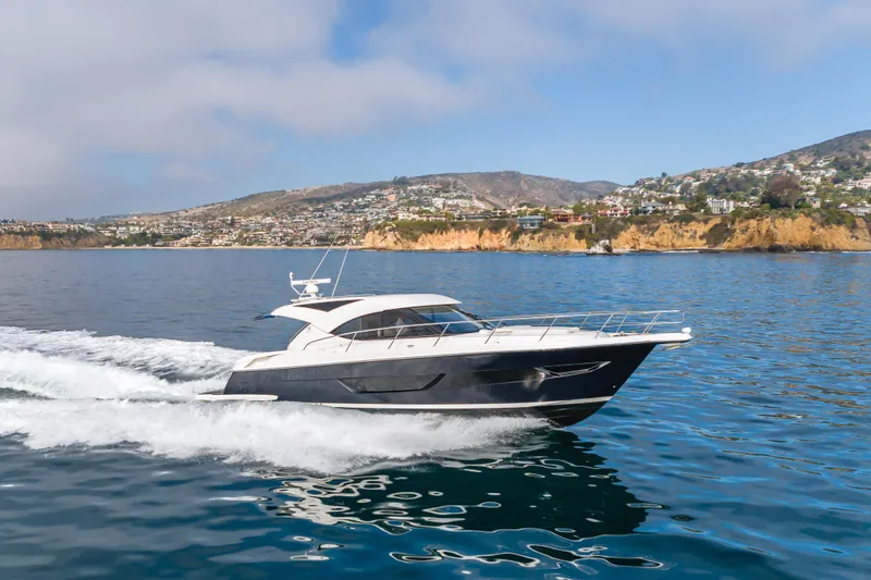 No Contingencies Yacht Photos Pics 2012 Riviera 44 Sport Yacht cruising on scenic coastal waters.