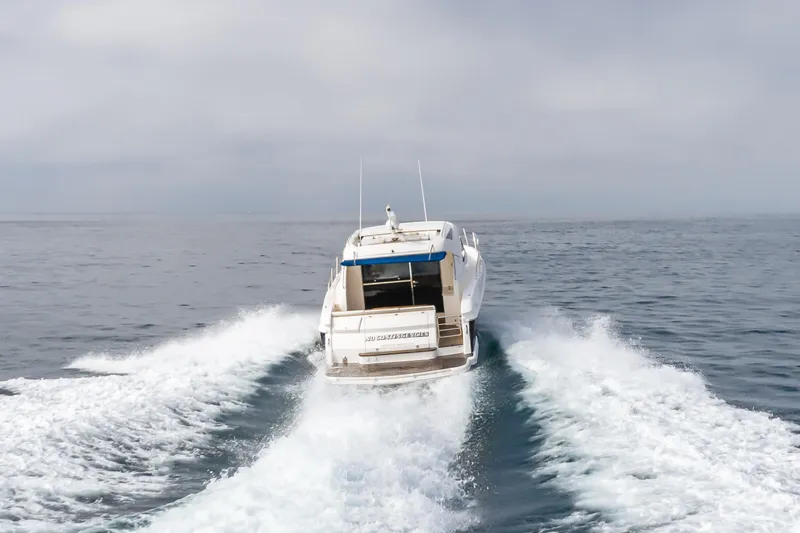 No Contingencies Yacht Photos Pics Riviera 44 Sport Yacht 2012 cruising on open sea, rear view.