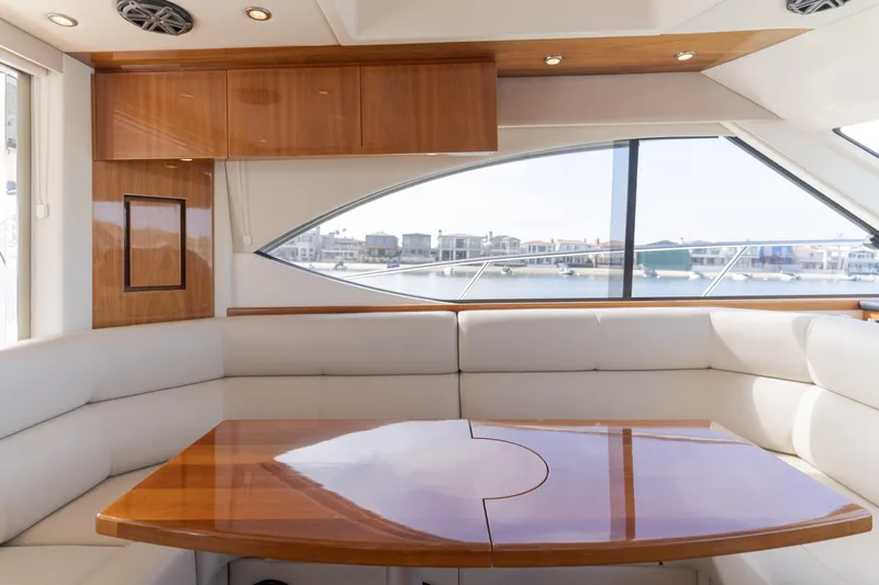 No Contingencies Yacht Photos Pics Luxurious interior of 2012 Riviera 44 Sport Yacht with elegant wood finishes and waterfront view.