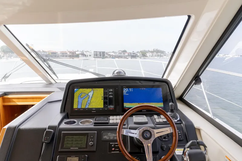 No Contingencies Yacht Photos Pics Cockpit view of 2012 Riviera 44 Sport Yacht with navigation screens and steering wheel.
