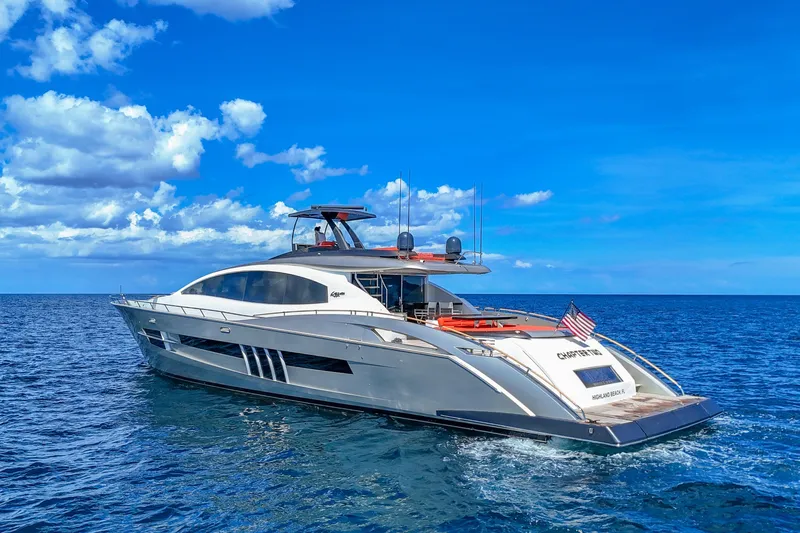  Yacht Photos Pics Luxurious 2010 Lazzara LSX 92 yacht cruising on open sea under clear blue sky.