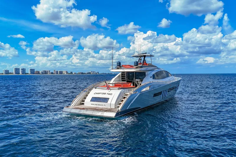  Yacht Photos Pics Luxurious 2010 Lazzara LSX 92 yacht cruising on open water under a vibrant sky.