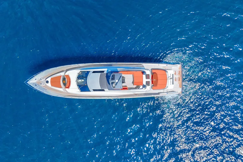  Yacht Photos Pics Aerial view of 2010 Lazzara LSX 92 yacht cruising on vibrant blue water.
