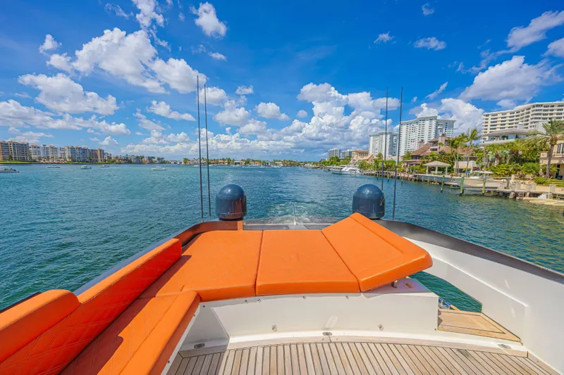  Yacht Photos Pics Luxury Lazzara LSX 92 yacht, 2010 model, cruising on a sunny waterfront with vibrant orange seating.