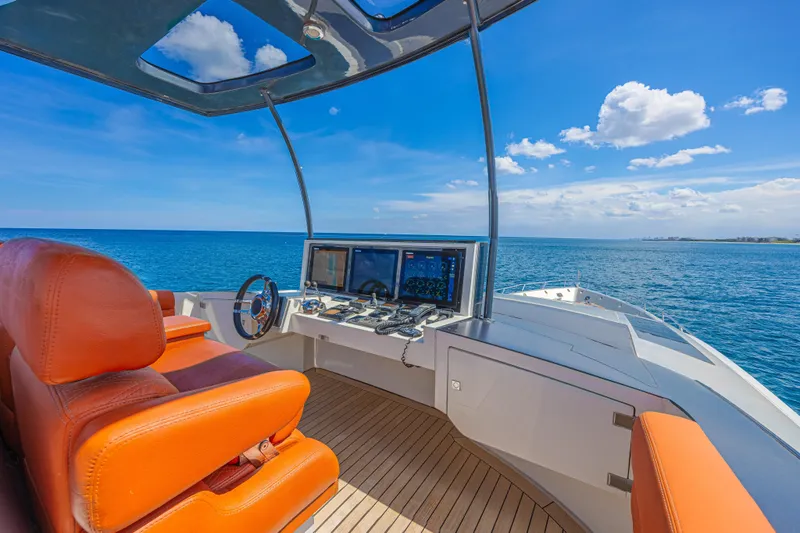  Yacht Photos Pics Luxurious 2010 Lazzara LSX 92 yacht helm with orange seats and ocean view.