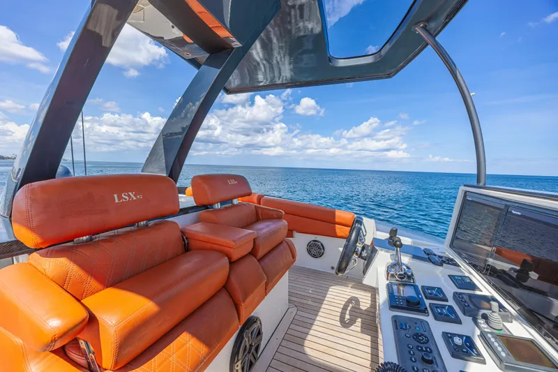  Yacht Photos Pics Luxurious 2010 Lazzara LSX 92 yacht cockpit with orange seating and ocean view.