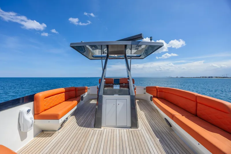  Yacht Photos Pics Luxurious 2010 Lazzara LSX 92 yacht with orange seating, cruising on open sea.