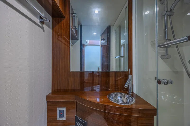  Yacht Photos Pics Luxurious bathroom interior of 2010 Lazzara LSX 92 yacht with modern fixtures.