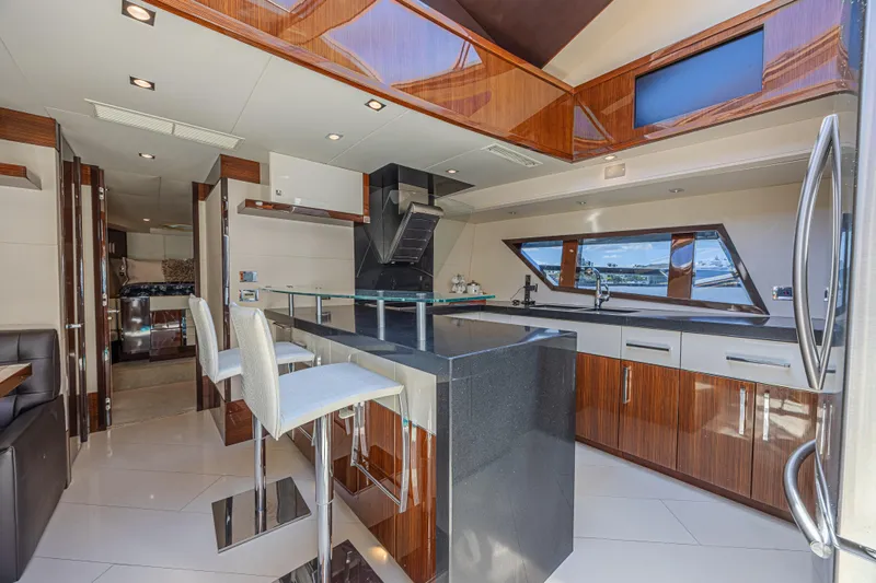  Yacht Photos Pics Luxurious interior of 2010 Lazzara LSX 92 yacht with modern kitchen and seating area.
