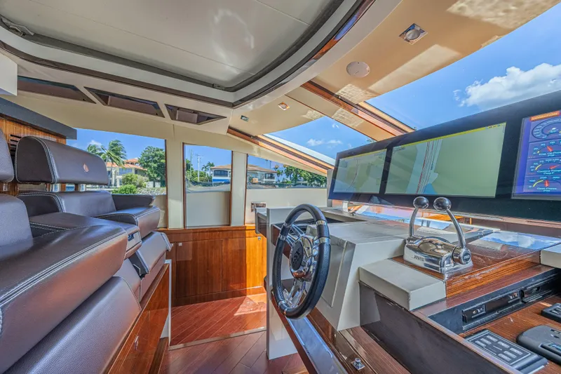  Yacht Photos Pics Luxurious 2010 Lazzara LSX 92 yacht helm with modern navigation systems and leather seating.