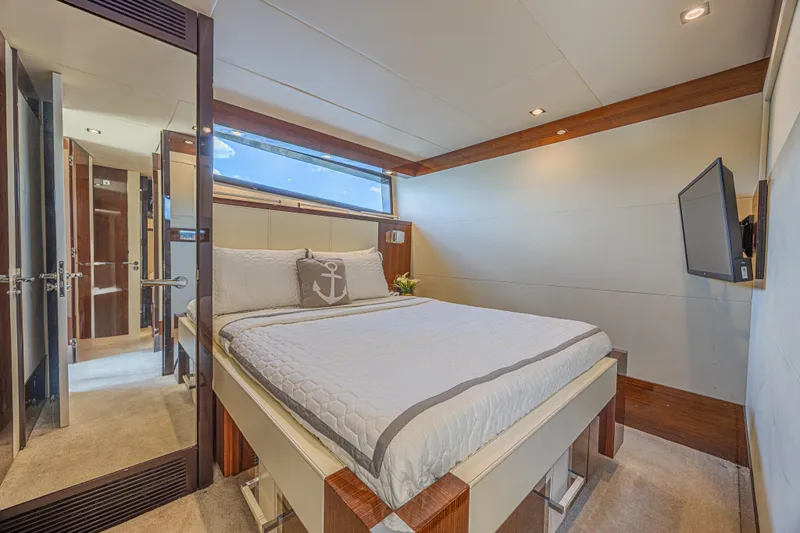  Yacht Photos Pics Luxurious bedroom interior of 2010 Lazzara LSX 92 yacht with modern decor and natural light.