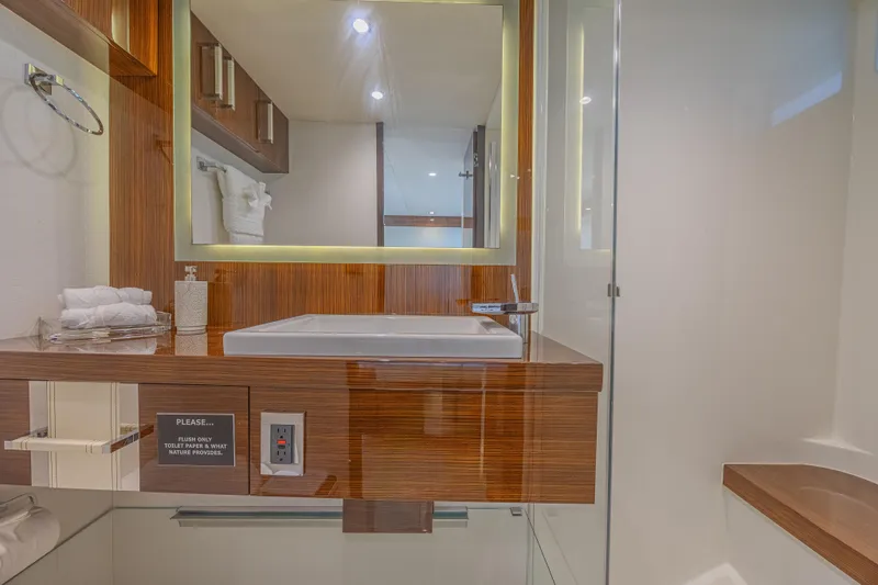  Yacht Photos Pics Luxurious bathroom interior of 2010 Lazzara LSX 92 yacht with modern sink and mirror.