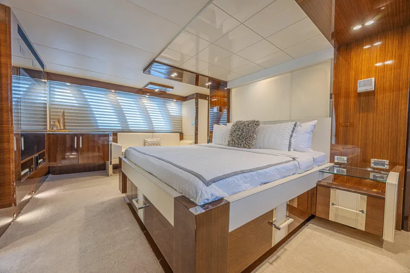  Yacht Photos Pics Luxurious bedroom interior of 2010 Lazzara LSX 92 yacht with modern design and elegant furnishings.