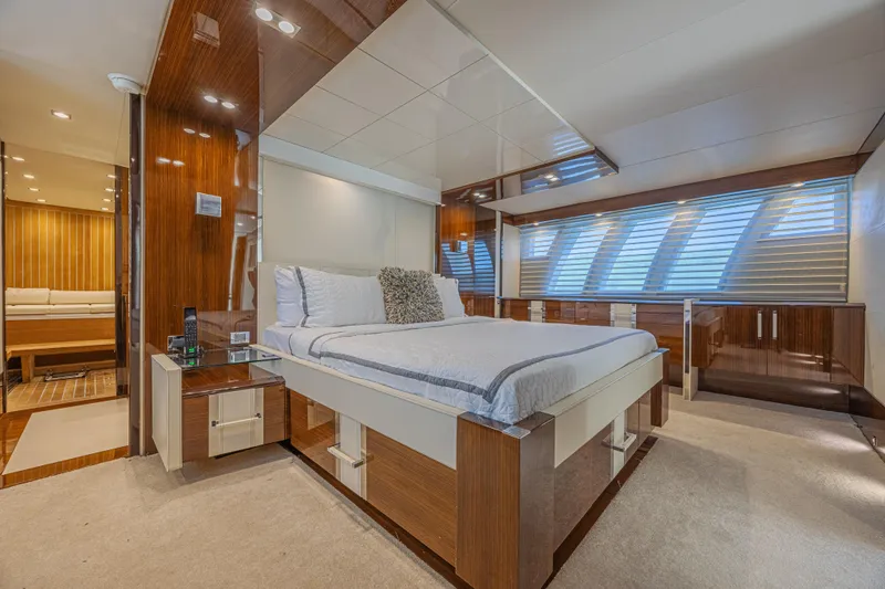  Yacht Photos Pics Luxurious bedroom interior of 2010 Lazzara LSX 92 yacht with modern design and elegant furnishings.