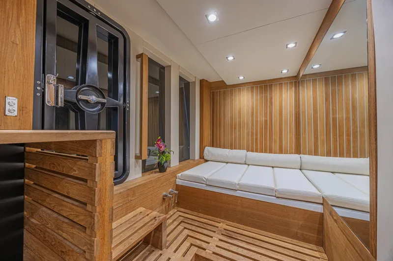  Yacht Photos Pics Luxurious interior of 2010 Lazzara LSX 92 yacht with wooden accents and white seating.