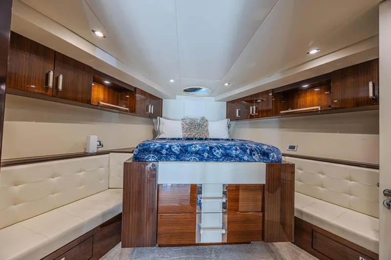  Yacht Photos Pics Luxurious 2010 Lazzara LSX 92 yacht interior with elegant wood finishes and plush bedding.