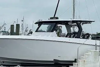  Yacht Photos Pics 2025 Fountain 38 SCX boat docked at a marina, showcasing sleek design and modern features.