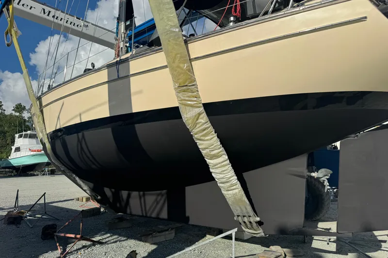 Buena Vida Yacht Photos Pics Island Packet 380 sailboat from 2000 in dry dock, hull visible, sunny day.