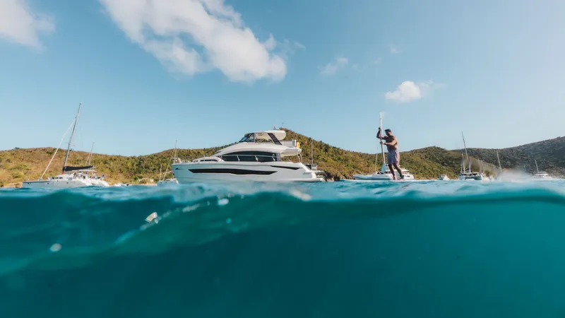 Grace Yacht Photos Pics Aquila 54 Yacht 2022 on water with paddleboarder.