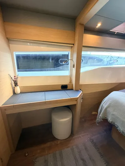Grace Yacht Photos Pics Interior of 2022 Aquila 54 yacht with desk and window.