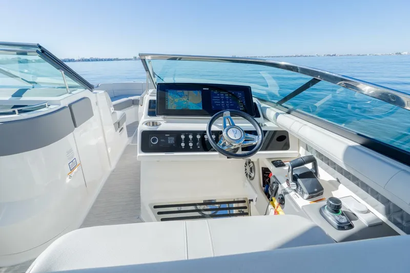  Yacht Photos Pics 2023 Sea Ray SLX 310 Outboard helm with modern controls and navigation system on open water.