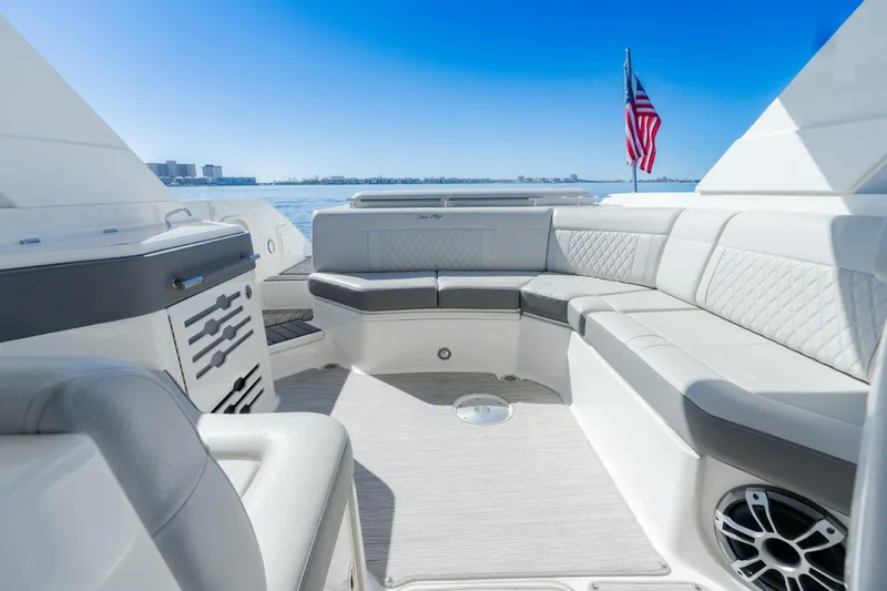 Yacht Photos Pics 2023 Sea Ray SLX 310 Outboard boat interior with luxurious seating and American flag.