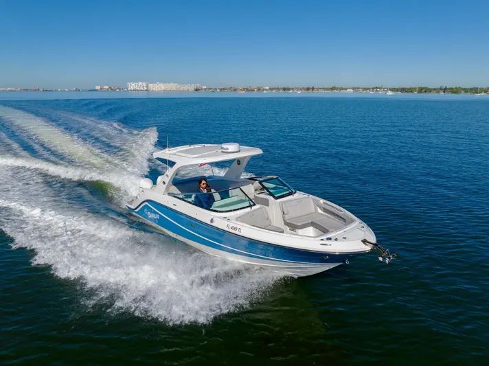 Yacht Photos Pics 2023 Sea Ray SLX 310 Outboard cruising on open water under clear blue skies.