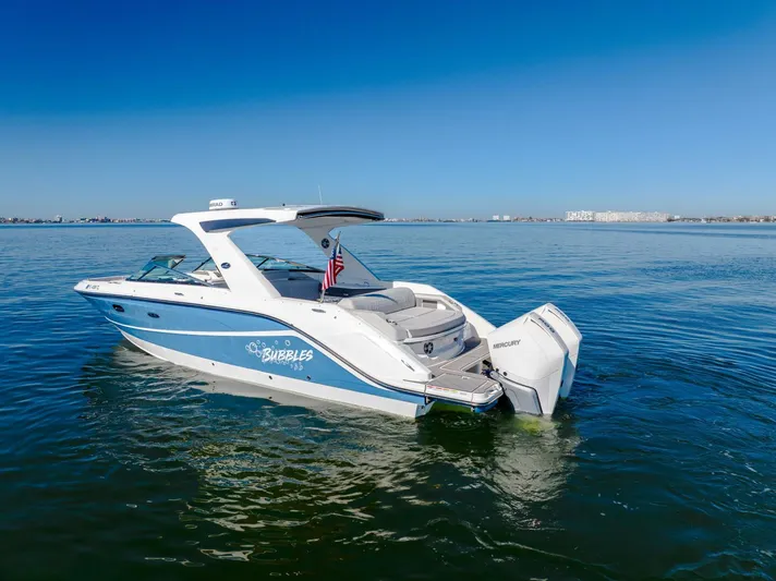  Yacht Photos Pics 2023 Sea Ray SLX 310 Outboard boat on calm water, blue sky background.
