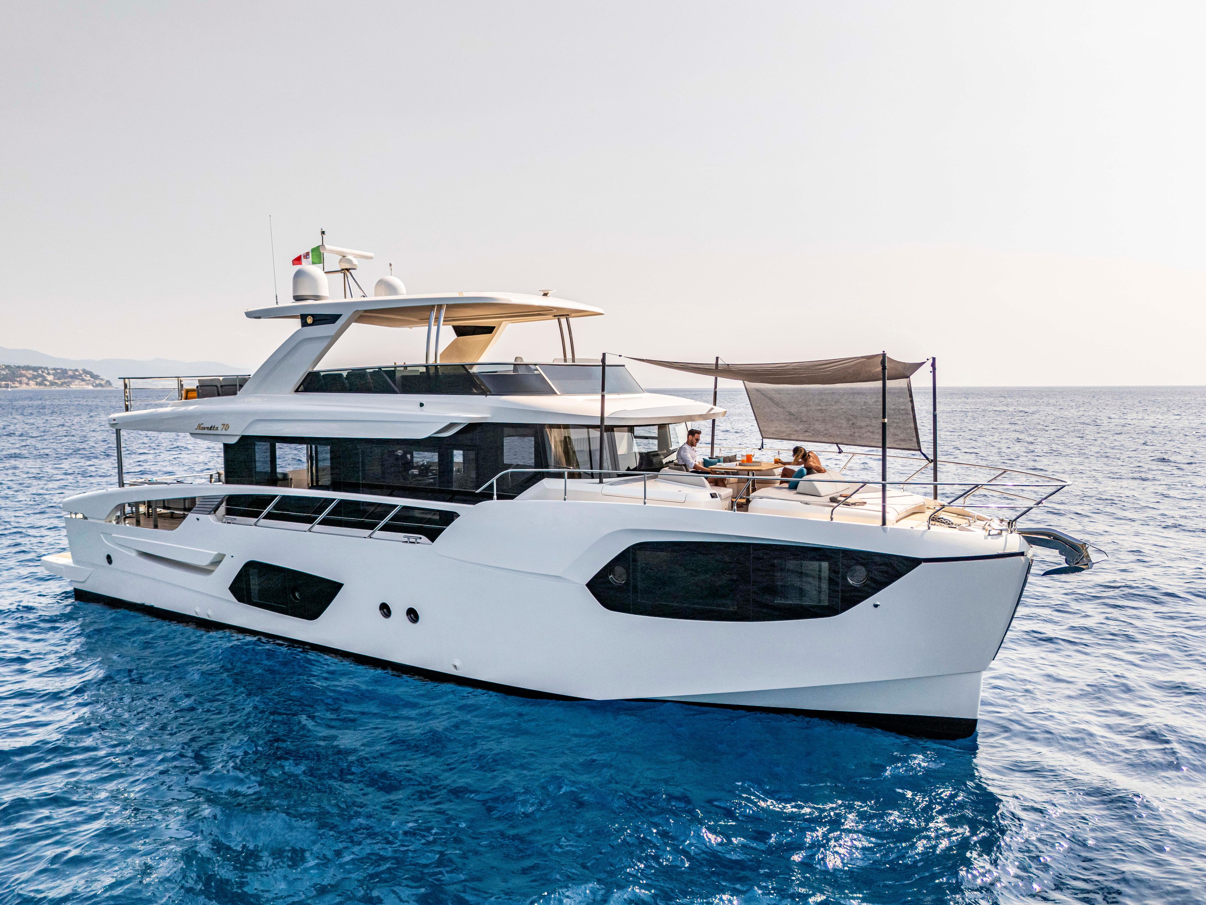 Luxury Absolute 70 N yacht on serene blue waters, 2026 model, showcasing elegant design.