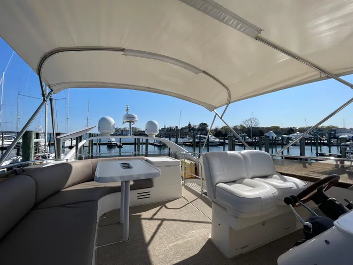  Yacht Photos Pics Flybridge of 2005 Viking Princess 50, featuring seating and helm, docked at marina.