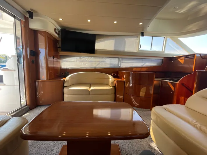  Yacht Photos Pics Luxurious interior of 2005 Viking Princess 50 Flybridge yacht with elegant seating and wood finishes.