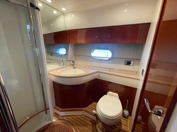  Yacht Photos Pics Luxurious bathroom in 2005 Viking Princess 50 Flybridge yacht with modern fixtures and wood accents.