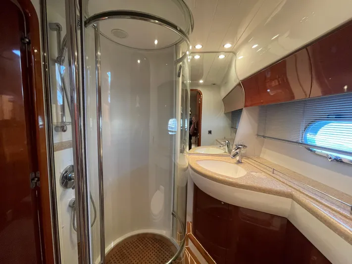  Yacht Photos Pics Luxurious bathroom in 2005 Viking Princess 50 Flybridge yacht with modern shower and elegant fixtures.