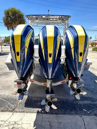  Yacht Photos Pics 2022 Midnight Express 37 Open boat with dual outboard engines, vibrant blue and yellow design.