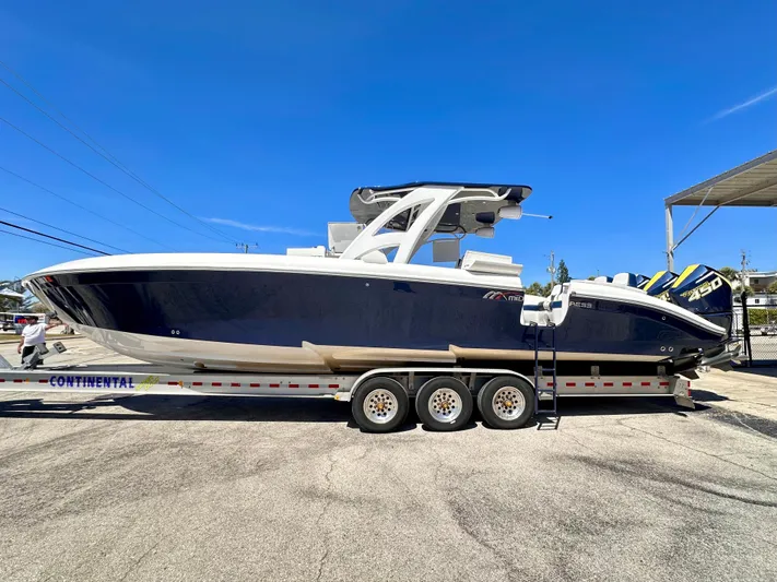  Yacht Photos Pics 2022 Midnight Express 37 Open boat on trailer under clear blue sky.