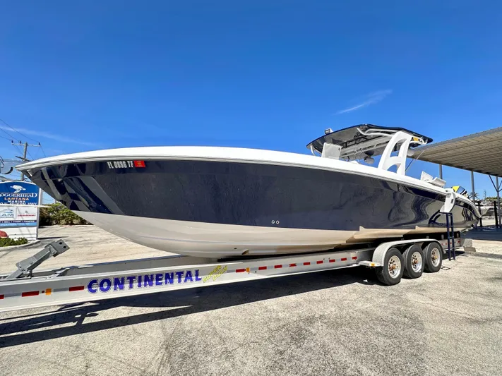  Yacht Photos Pics 2022 Midnight Express 37 Open boat on Continental trailer, parked outdoors.