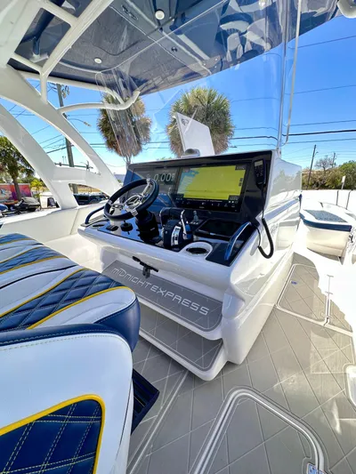  Yacht Photos Pics 2022 Midnight Express 37 Open boat cockpit with modern navigation system and luxurious seating.