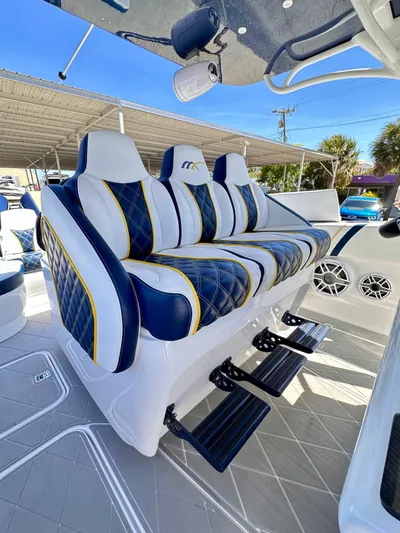  Yacht Photos Pics Luxury seating on 2022 Midnight Express 37 Open boat, featuring blue and white upholstery.