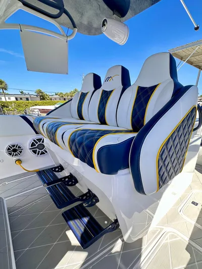  Yacht Photos Pics Luxury seating on 2022 Midnight Express 37 Open boat, featuring blue and white upholstery.