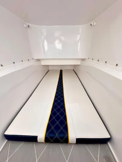  Yacht Photos Pics 2022 Midnight Express 37 Open cabin interior with sleek white and blue cushioned seating.