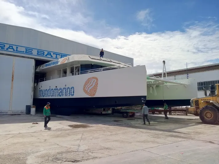  Yacht Photos Pics 2025 Squalt Marine CK 80 catamaran being moved from a shipyard building.