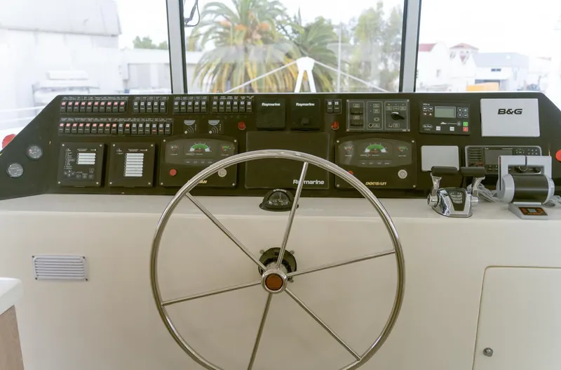  Yacht Photos Pics Control panel of 2025 Squalt Marine CK 80 yacht with steering wheel and navigation instruments.