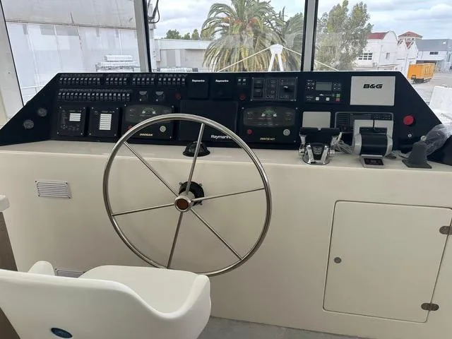  Yacht Photos Pics Control panel of 2025 Squalt Marine CK 80 yacht with steering wheel and navigation instruments.
