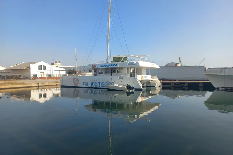  Yacht Photos Pics Modern Squalt Marine CK 80 catamaran docked in a serene marina, 2025 model.