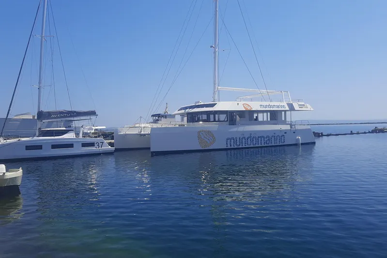  Yacht Photos Pics Modern Squalt Marine CK 80 catamaran docked in a serene marina, 2025 model.