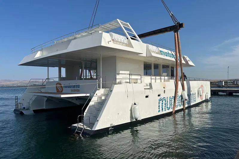  Yacht Photos Pics Modern Squalt Marine CK 80 catamaran, 2025 model, docked in a serene harbor.