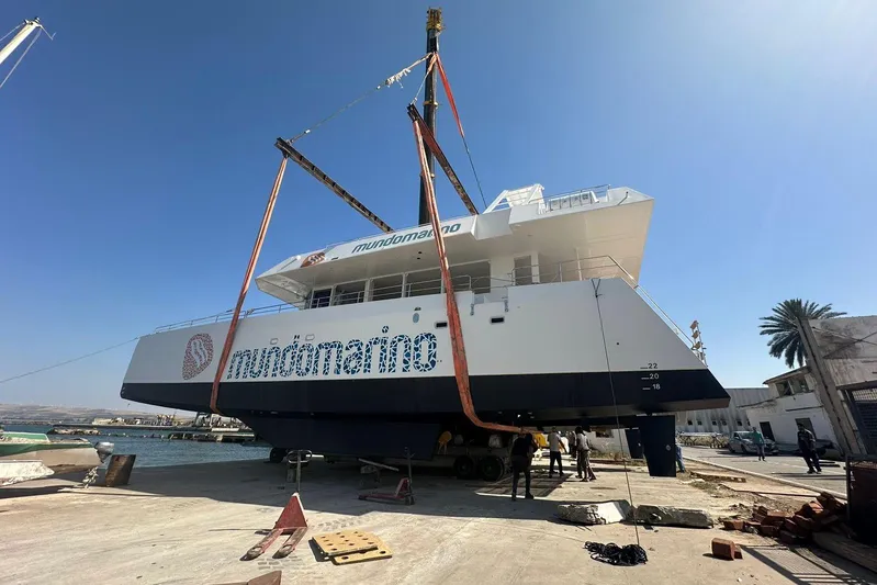  Yacht Photos Pics Large Squalt Marine CK 80 boat being lifted at a dock, clear blue sky.